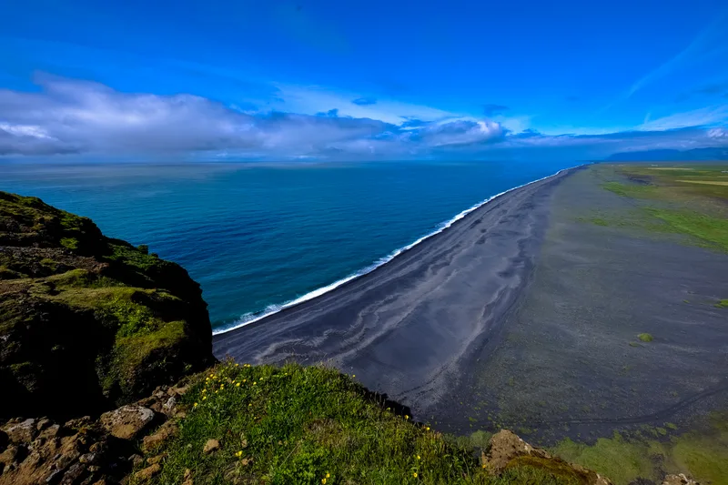 Aerial Shot Shoreline Near Mountain Blue Sky Daytime