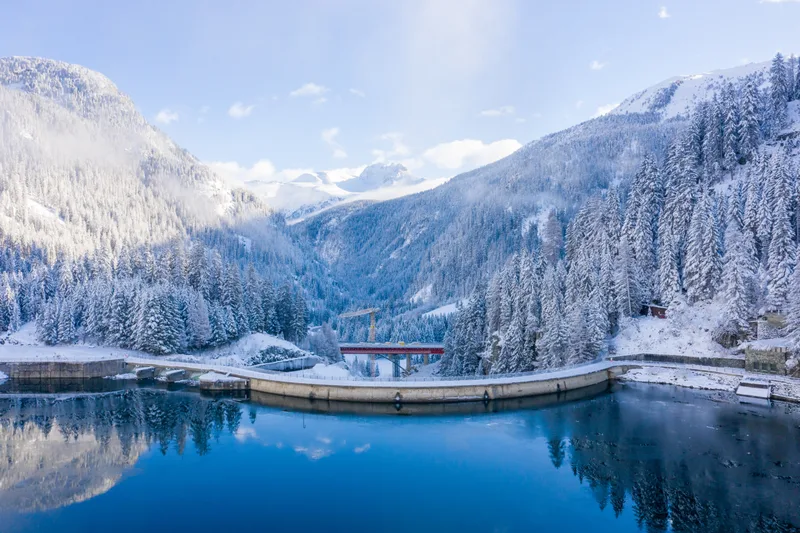 Aerial Shot Snow Capped Mountains With Calm Lake Daytime