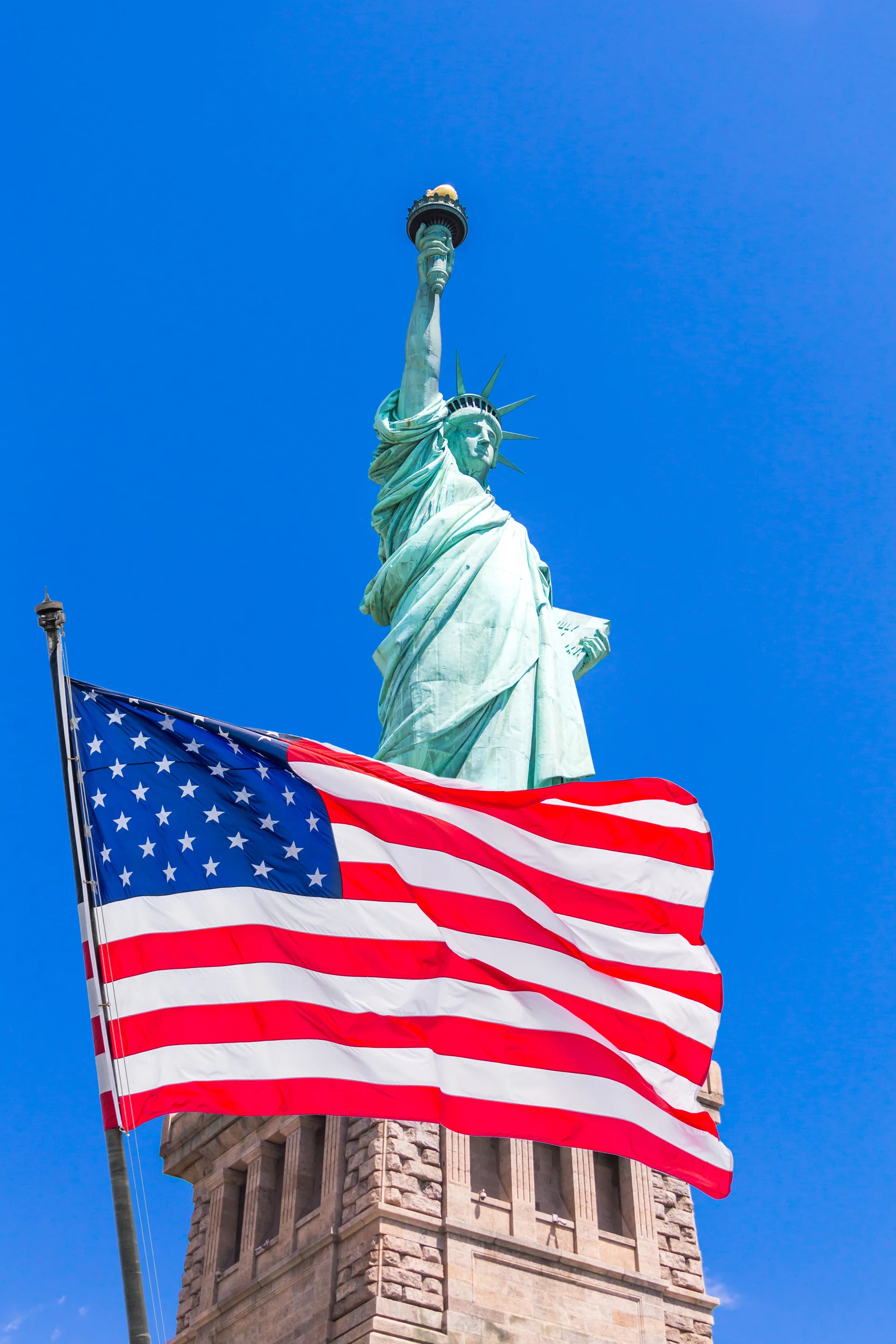 American Flag Waving Wind Against Statue Liberty. Uncategorized wallpaper. 2900×4350px. Free download for personal use.