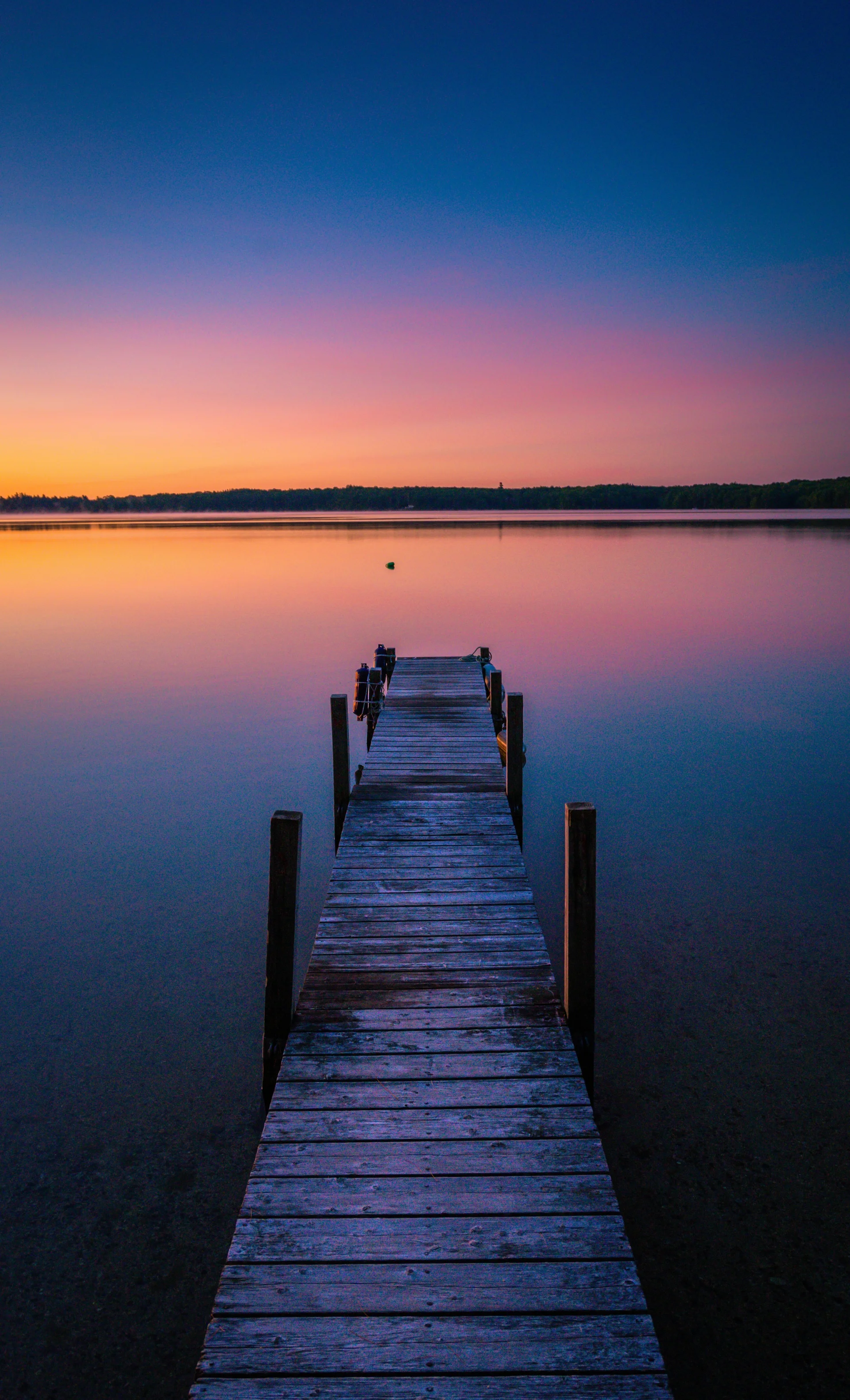 Beautiful Shot Sunset Colors Horizon Tranquil Lake With Dock. Nature wallpaper. 3359×5532px. Free download for personal use.