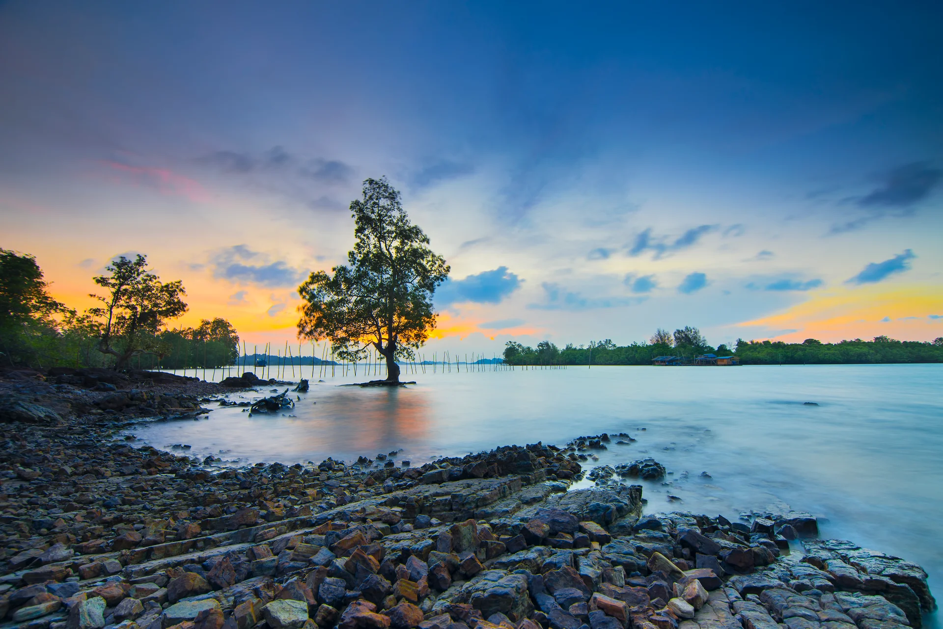 Beautiful Sunset With Rocks Along Beach. Nature wallpaper. 5965×3982px. Free download for personal use.