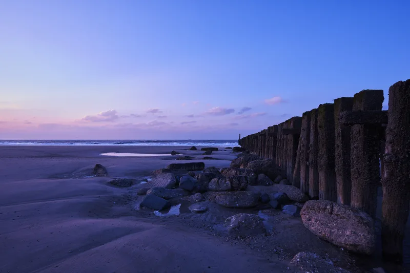 Beautiful View Sunset With Purple Clouds Fence Beach