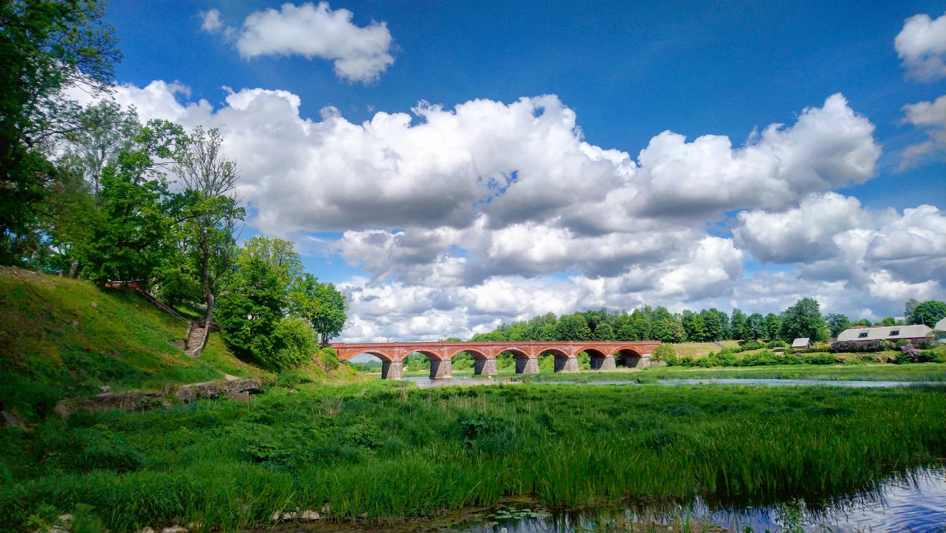 Bridge River Against Sky. Nature wallpaper. 5984×3376px. Free download for personal use.