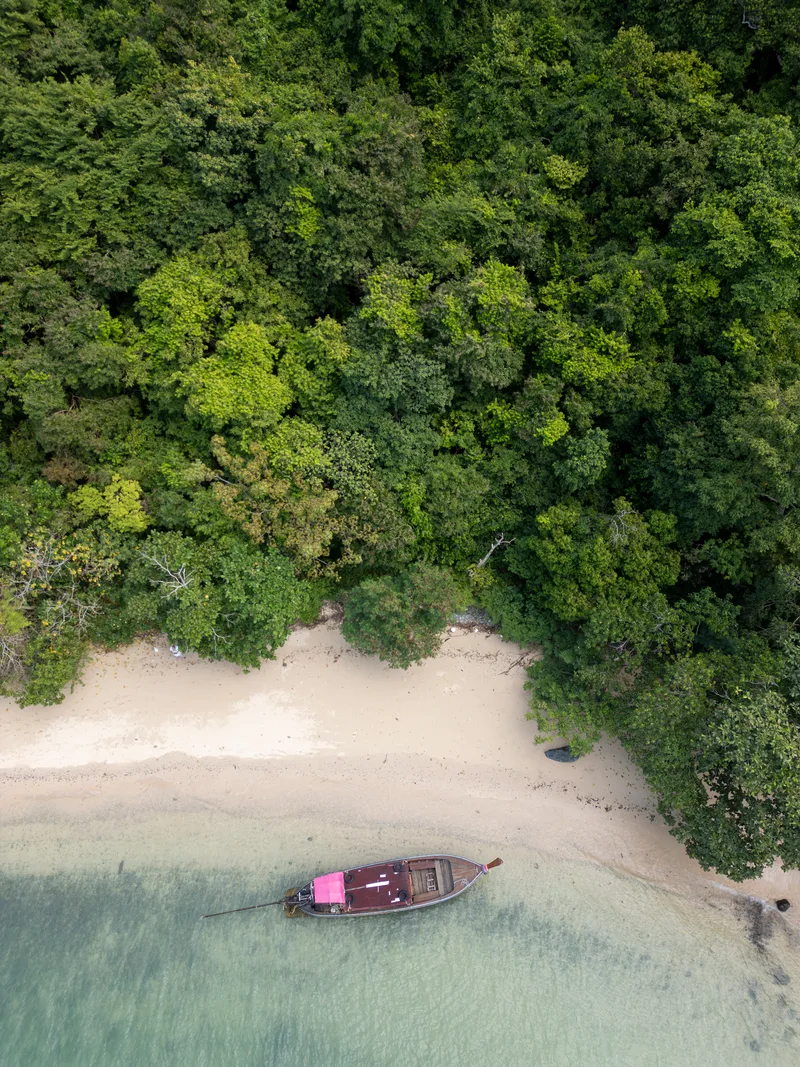 Drone Shot Tropical Sandy Beach With Sailboat Shore