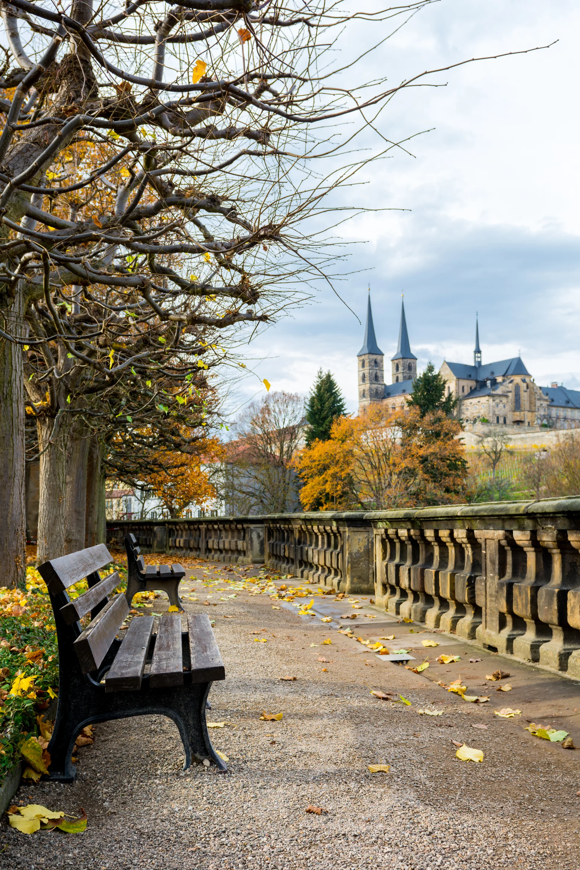 Empty Benches Footpath Against Sky Bamberg. Uncategorized wallpaper. 4000×6000px. Free download for personal use.