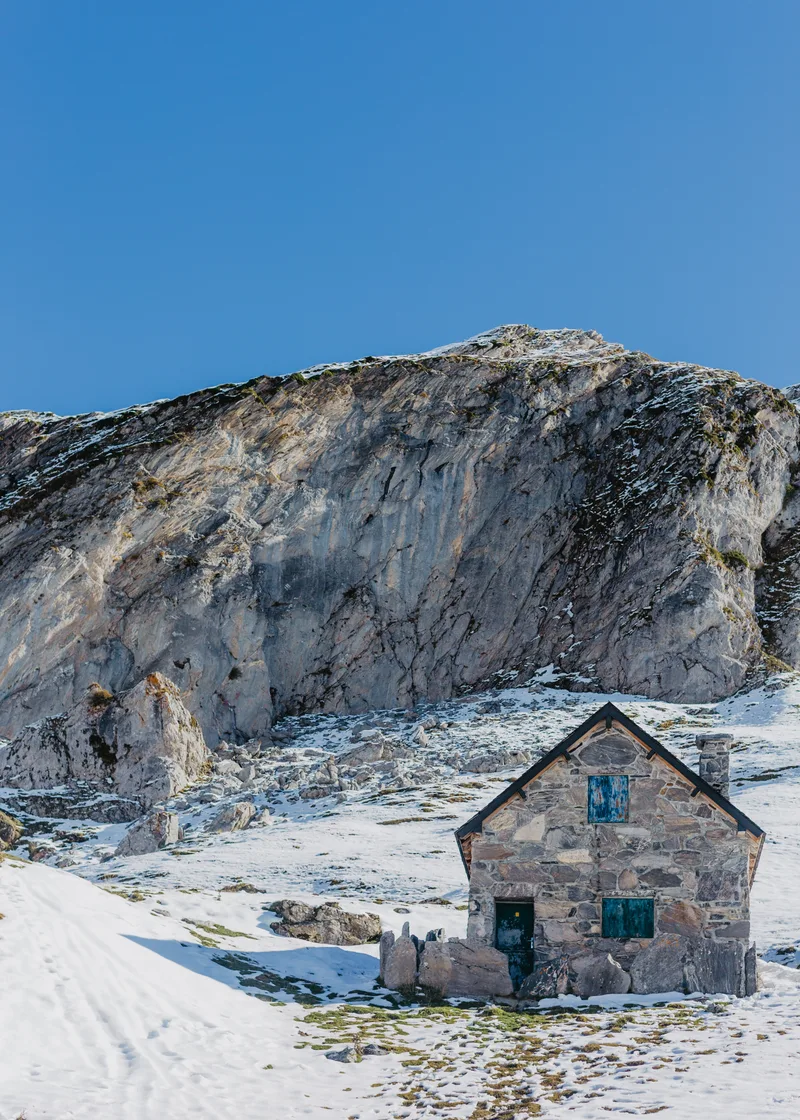Handbuilt Grey Stone House With High Rocks Beautiful Clear Blue Sky Background