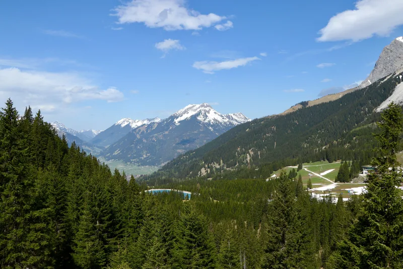 High Angle Shot Beautiful Mountain Range Covered With Green Fir Trees Snow Cloudy Sky