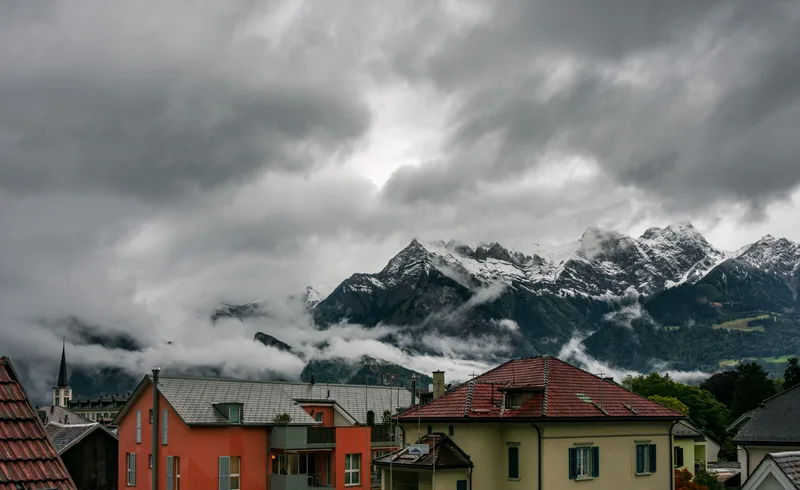 Houses Against Cloudy Sky
