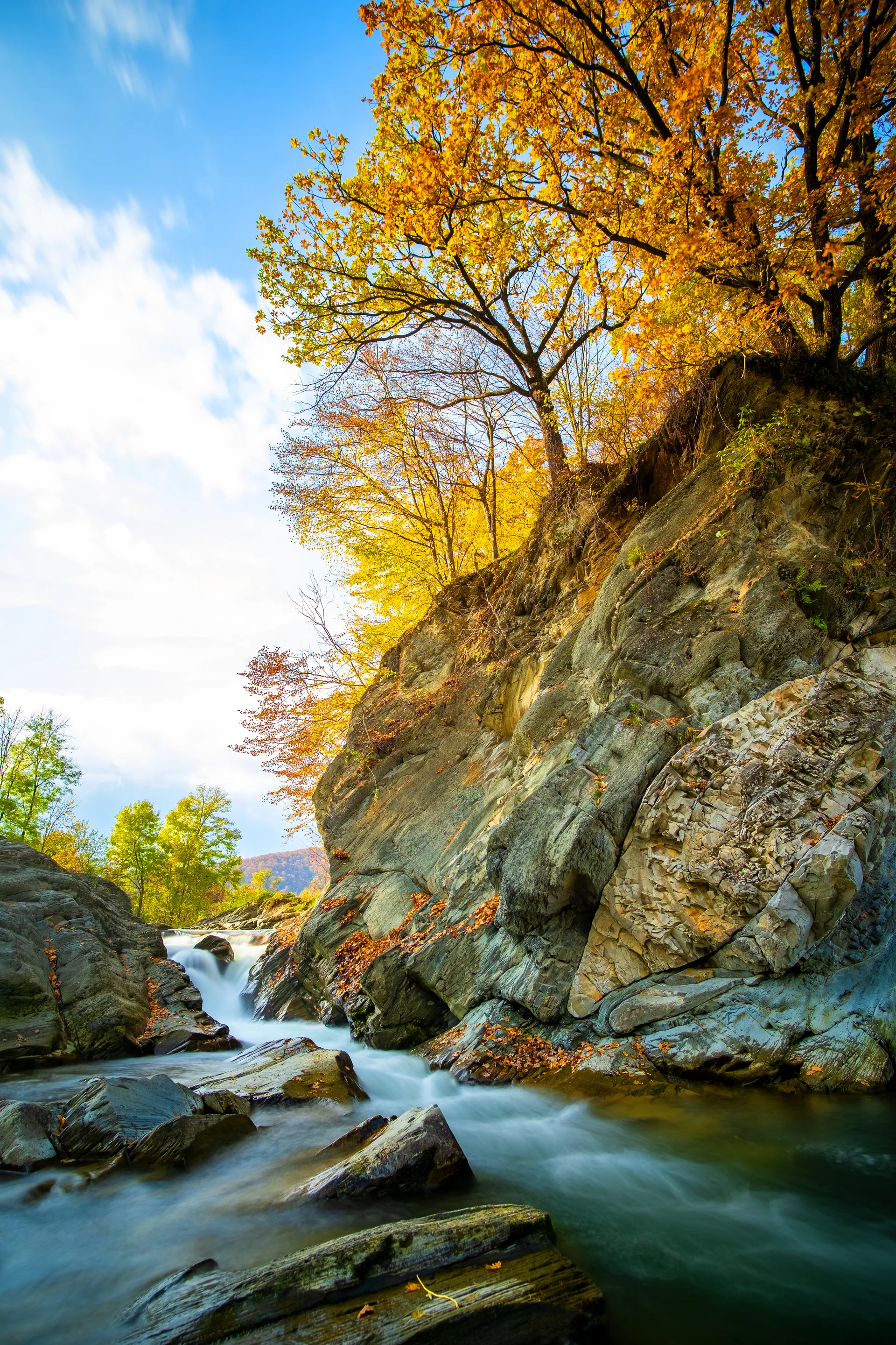 Mountain River With Small Waterfall With Clear Turquoise Water Falling Down Wet Boulders With Thick White Foam Autumn Brig…