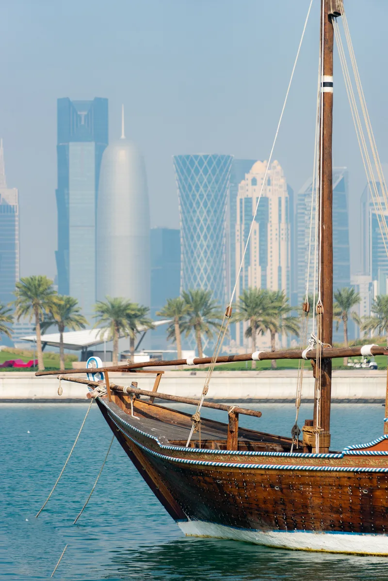 Retro Historical Boat With Blurred Panoramic View Modern Skyline Doha Green Palms Surface