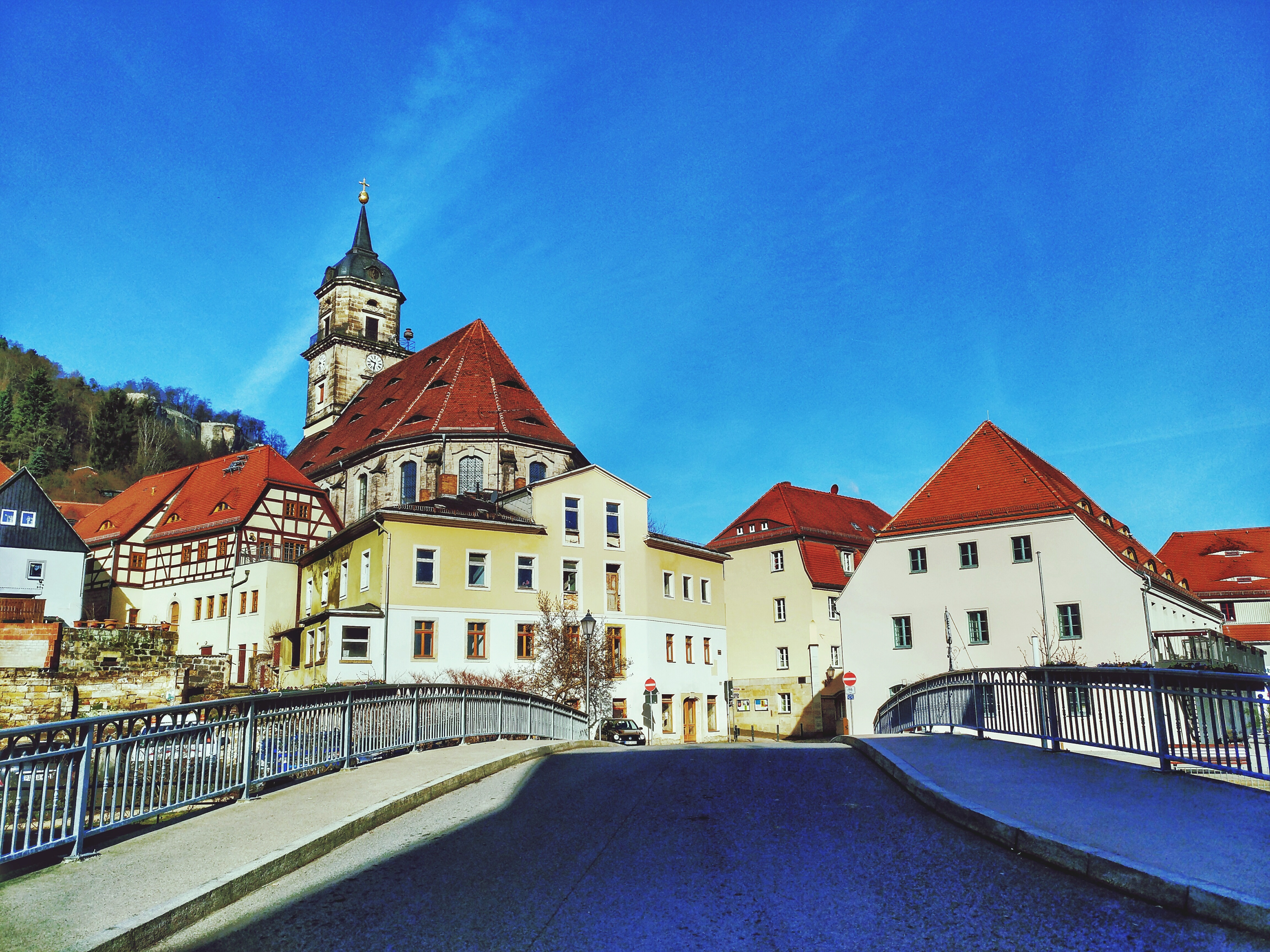 Road Leading Towards Church Against Blue Sky