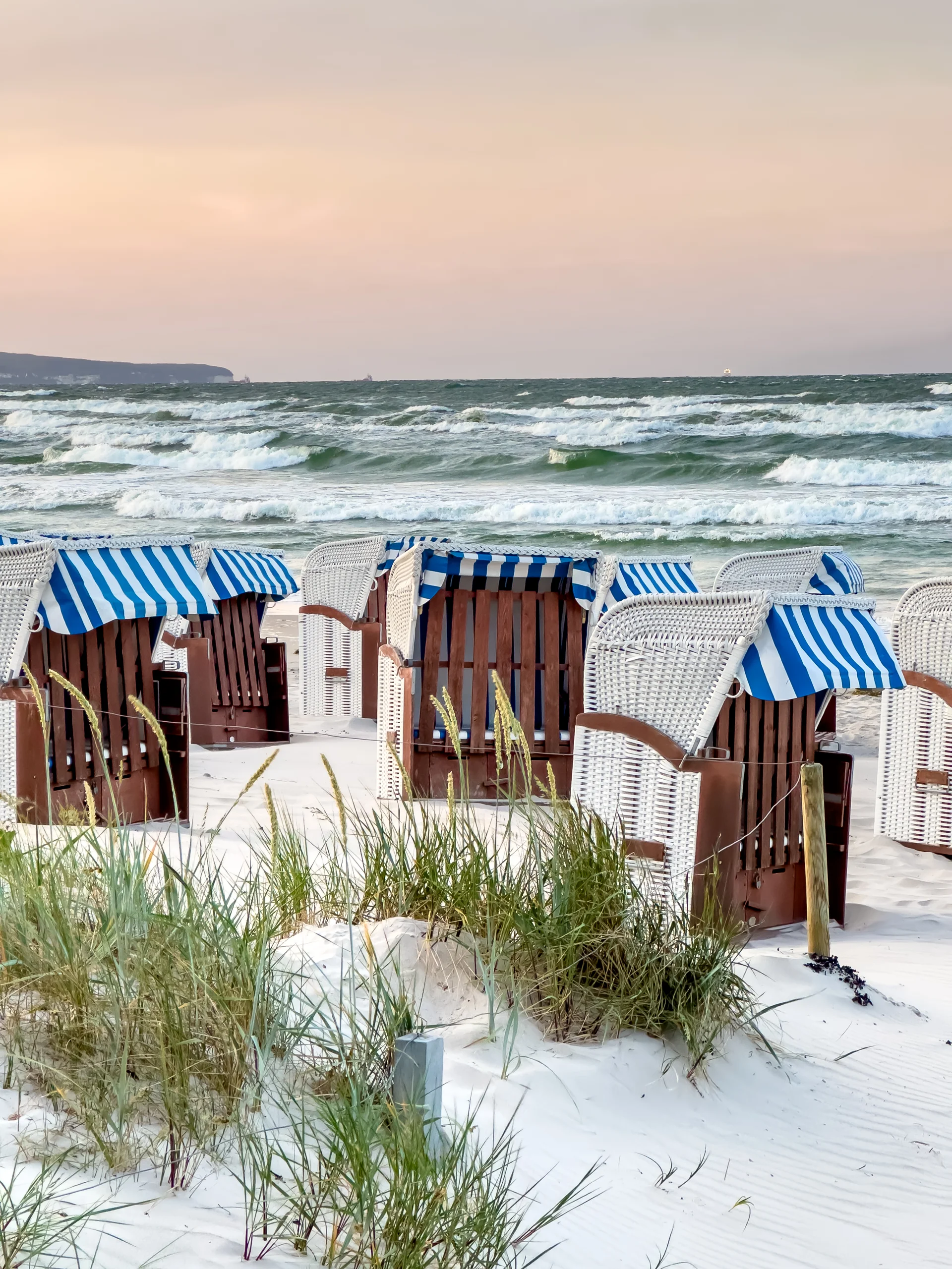 Sandy Beach By Sea With Dressing Rooms. Nature wallpaper. 3024×4032px. Free download for personal use.