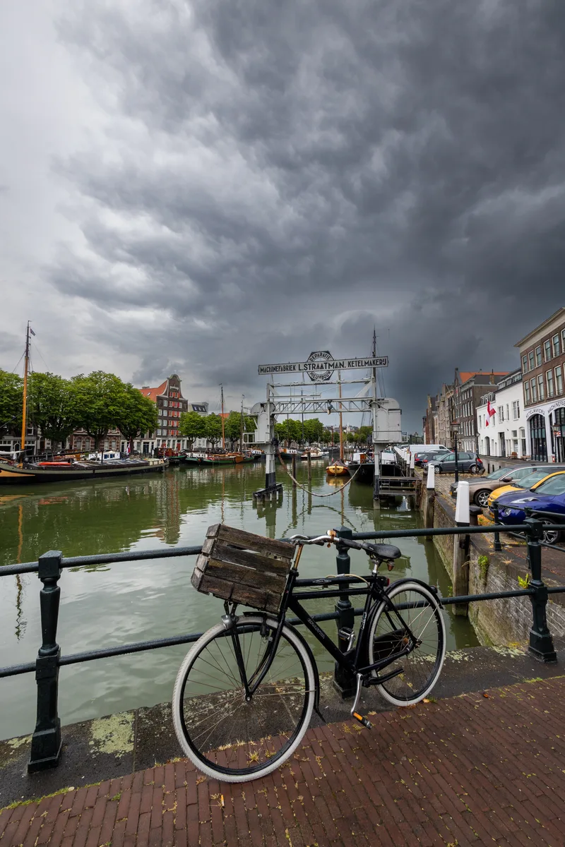 Scenic Canal With Vintage Bike Foreground Classic Dutch Houses Moored Boats