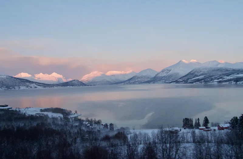 Scenic View Lake By Snowcapped Mountains Against Sky Sunset