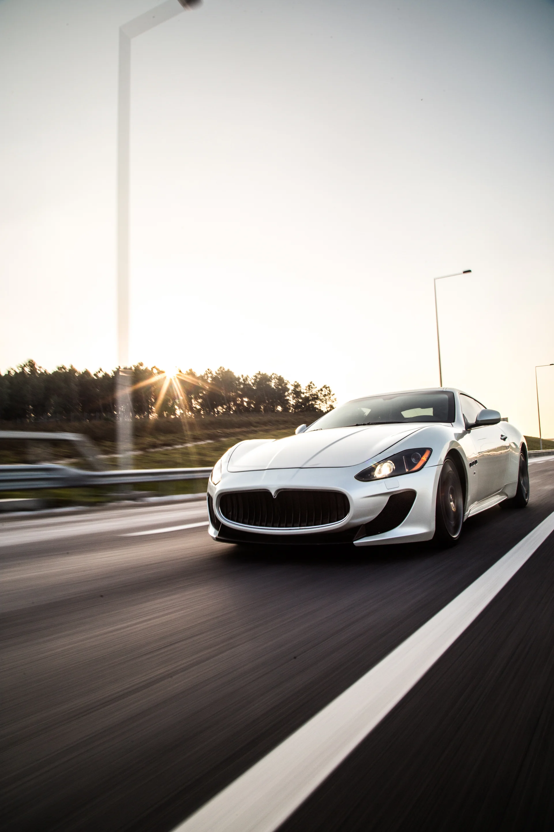 Sliver Metallic Color Sport Car Driving With High Speed Road. Cities wallpaper. 3648×5472px. Free download for personal use.