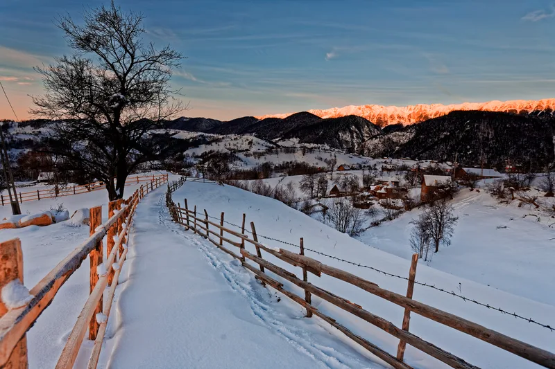 Snow Covered Landscape Against Sky