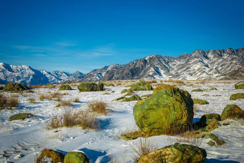Snow Covered Plain Mountains Against Blue Sky Sunny Winter Day
