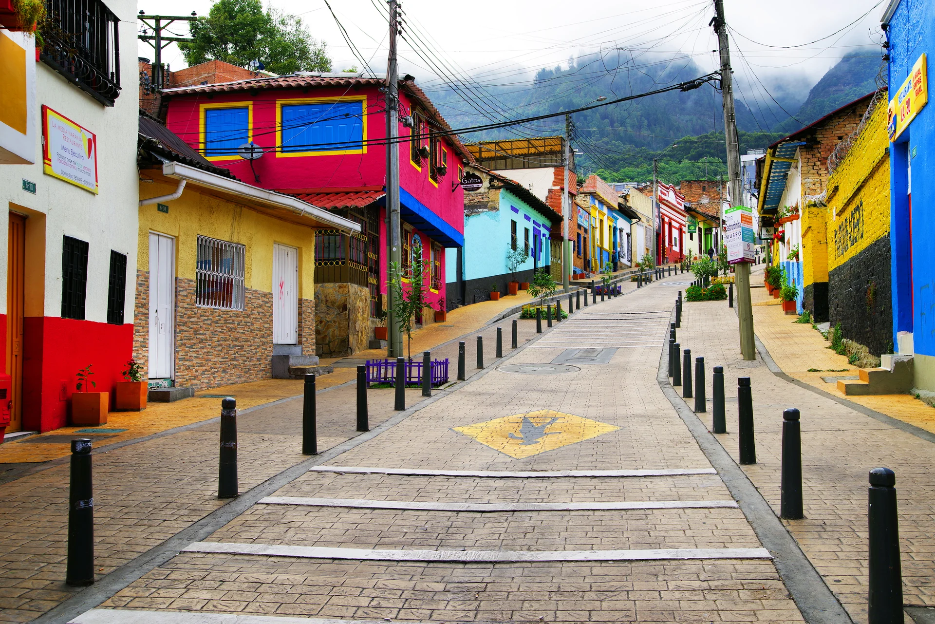 Street Amidst Buildings Town Against Mountain. Cities wallpaper. 3500×2336px. Free download for personal use.