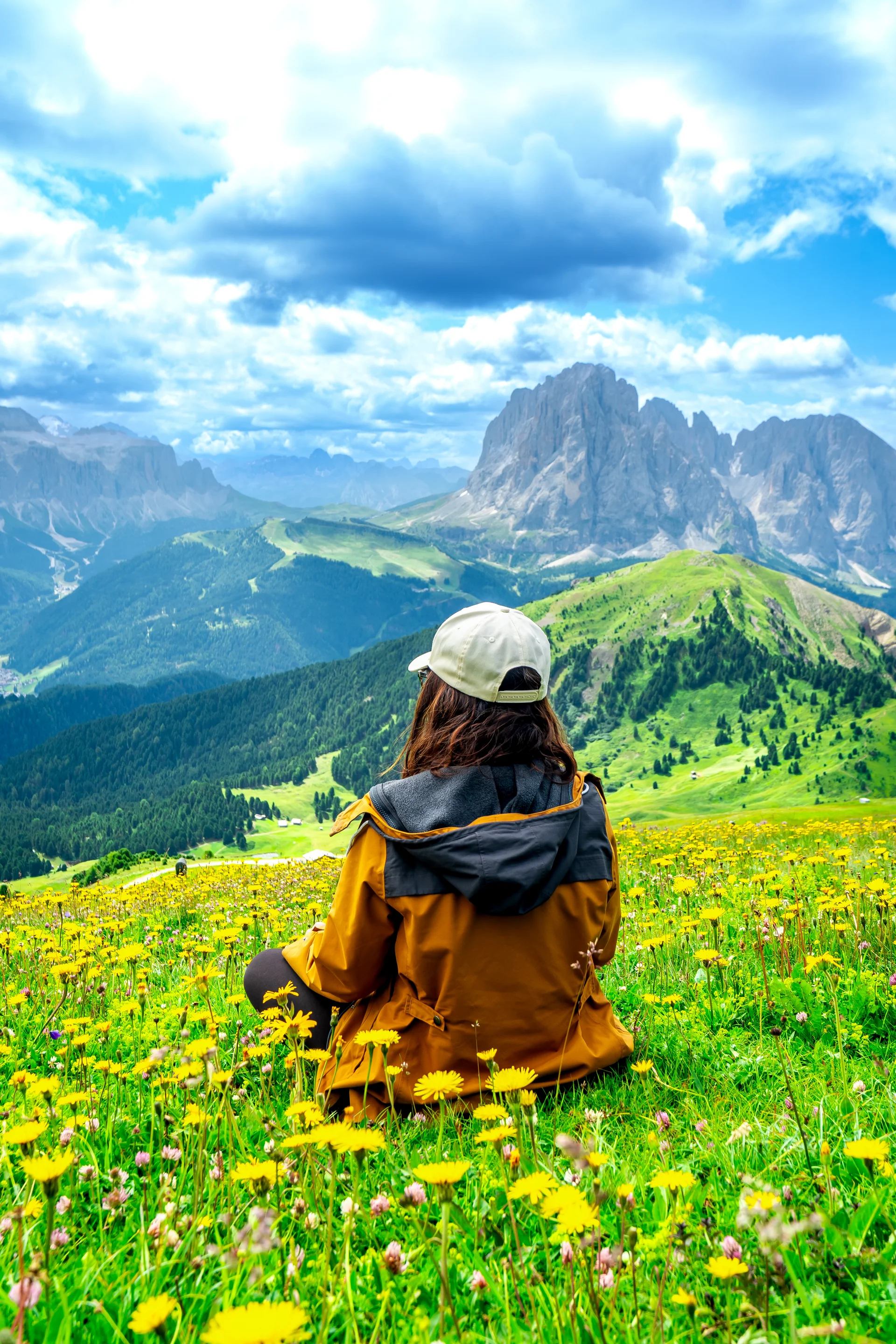 Tourist Enjoying Seceda Mountains Yellow Flowers Dolomites Italy. Nature wallpaper. 4000×6000px. Free download for persona…