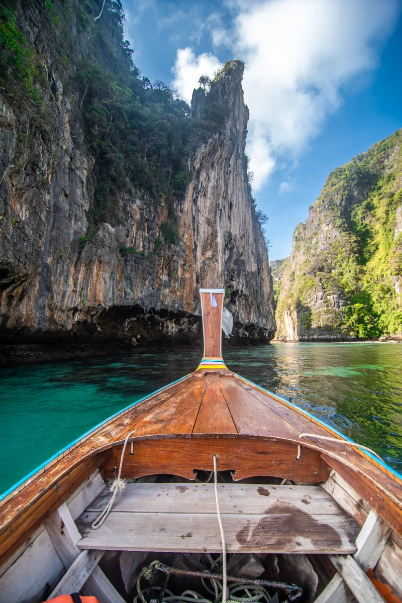 Traditional Wooden Longtail Taxi Boat Nose With Decoration Flowers Ribbons Maya Bay Beach Against Steep Limestone Hills Main Thailand Tourist Attraction Background Ko Phi Phi Leh Island