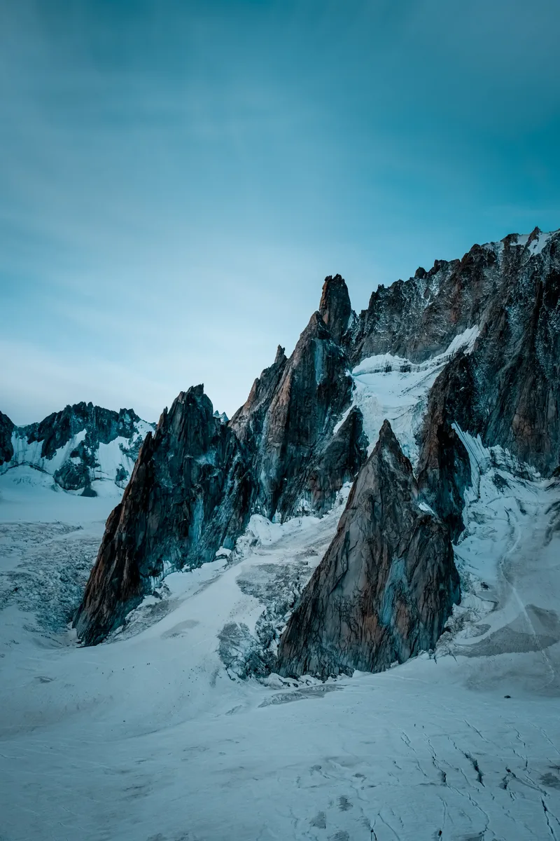 Vertical Shot Snowy Hill Near Mountain Blue Sky