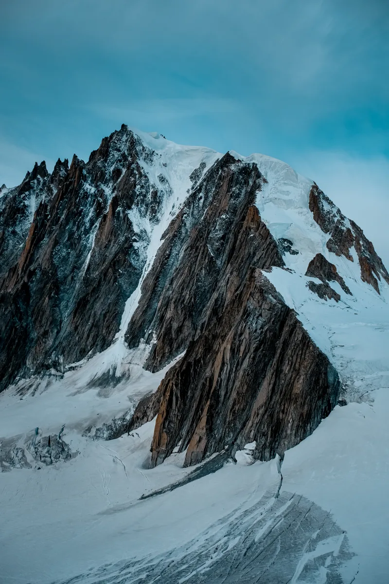 Vertical Shot Snowy Mountain With Blue Sky
