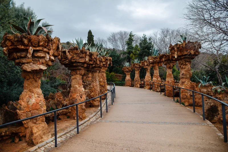 Walking Road Through Stone Columns Decorated With Exotic Bushes Top Guell Park Barcelona Concept Tourism Old Architecture