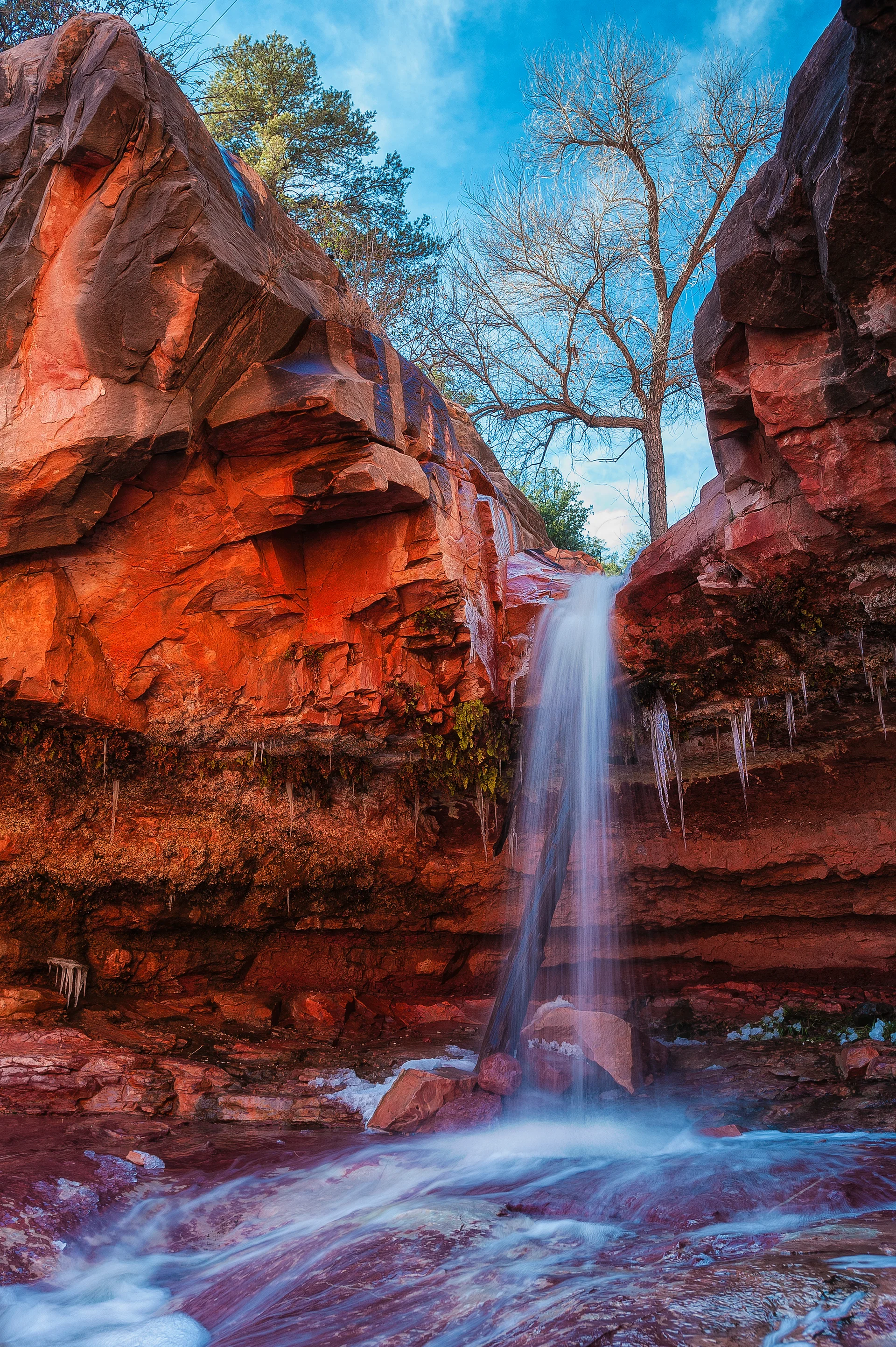 Waterfall Flowing Through Rocky Gorge Into Woods Red Rocks. Nature wallpaper. 2329×3499px. Free download for personal use.