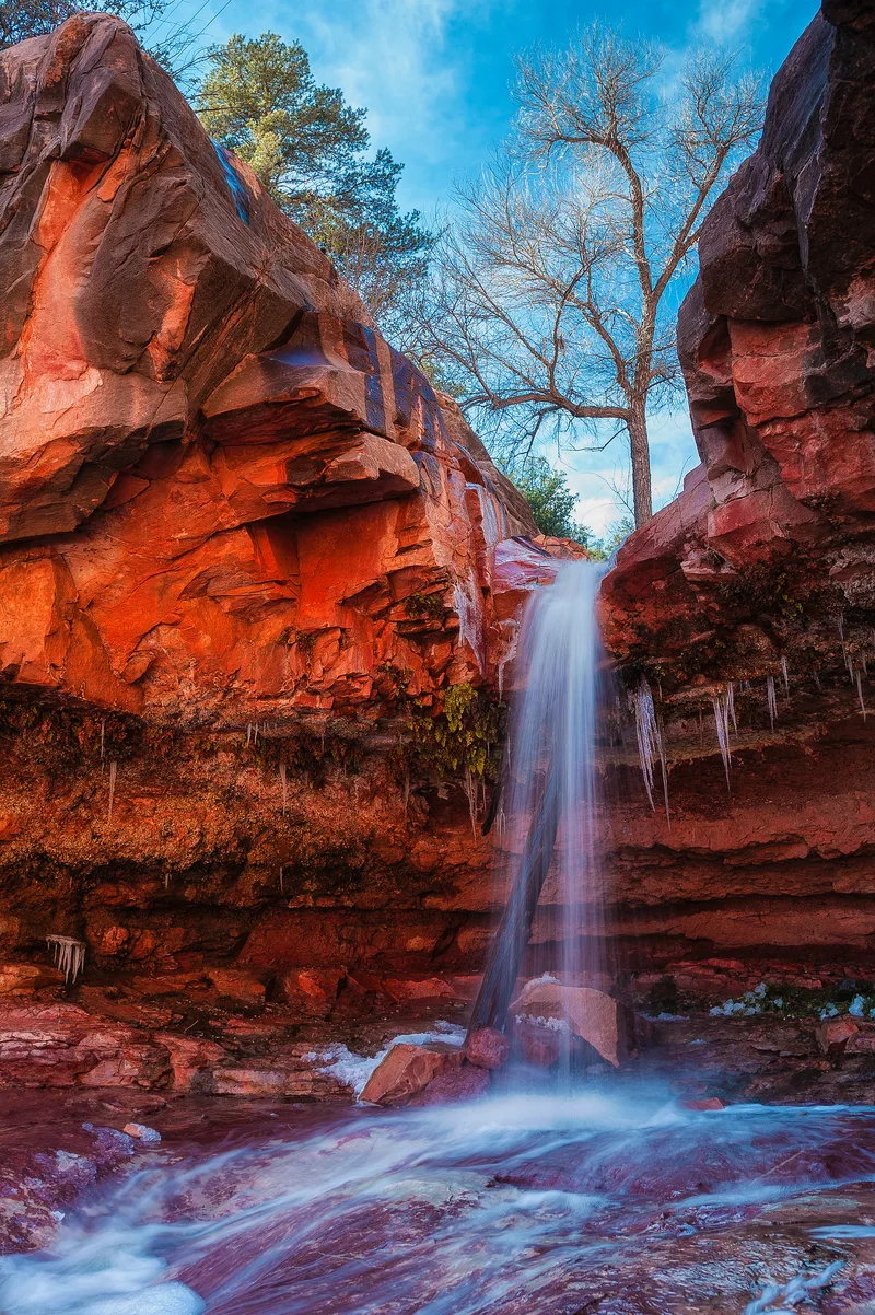 Waterfall Flowing Through Rocky Gorge Into Woods Red Rocks