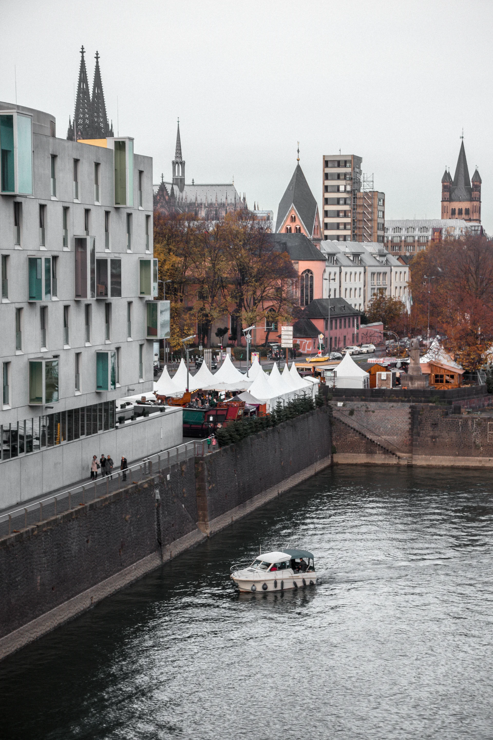 White Black Boat River Near Concrete Building. Dark wallpaper. 4000×6000px. Free download for personal use.