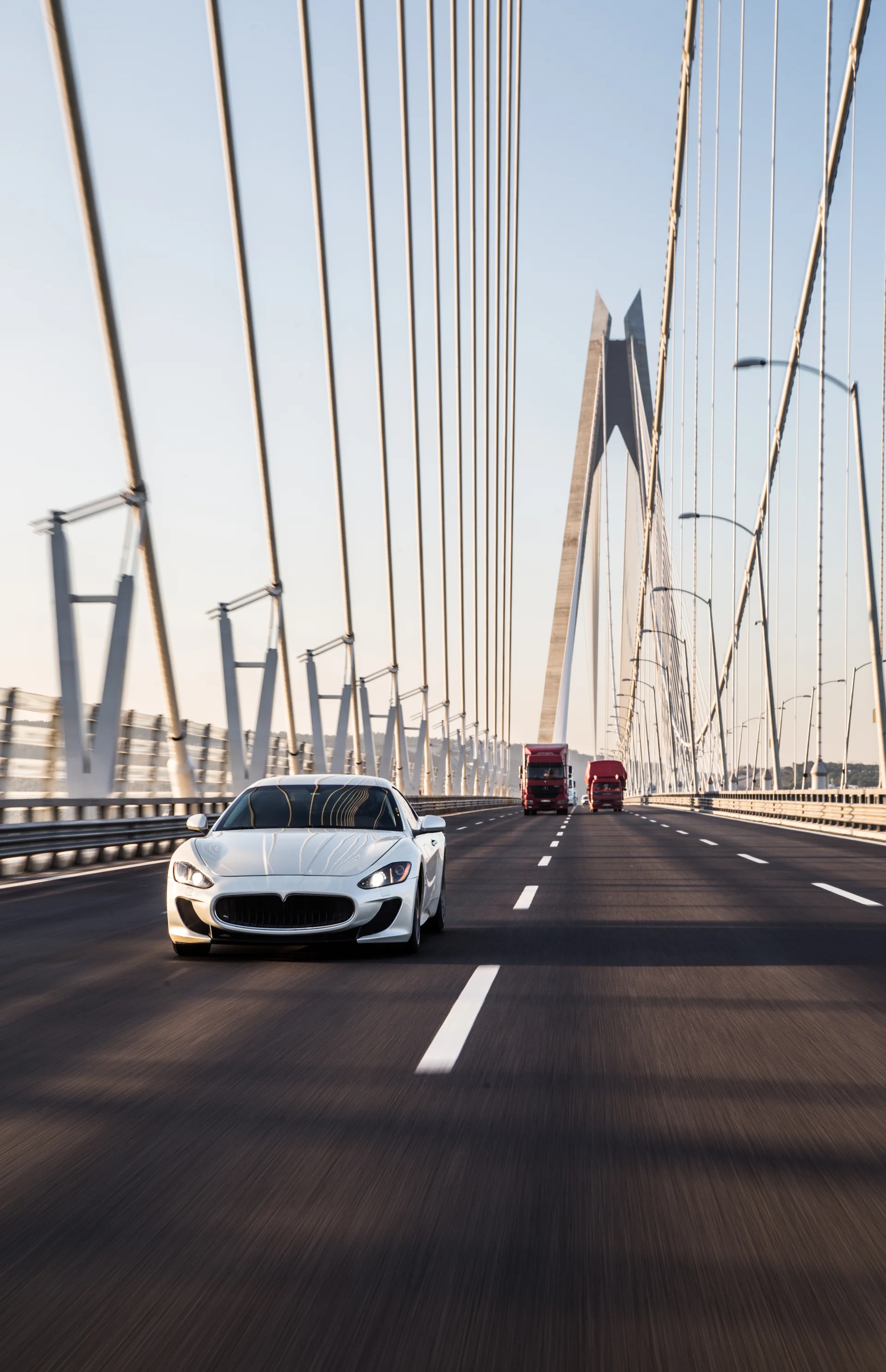 White Sedan Sport Car Driving Bridge. Cities wallpaper. 3534×5472px. Free download for personal use.