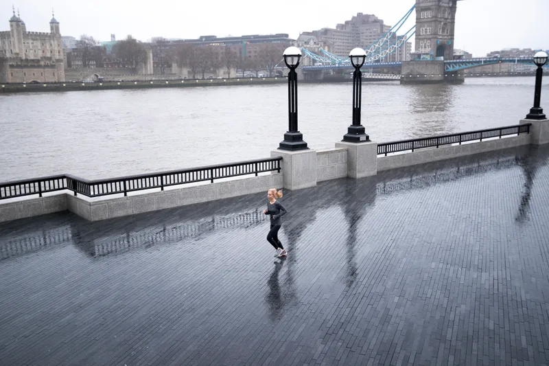 Woman Running Outside While It Rains