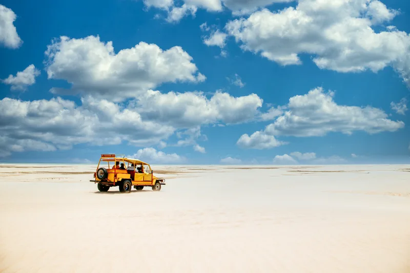 Yellow Truck Riding Sandy Ground Cloudy Blue Sky